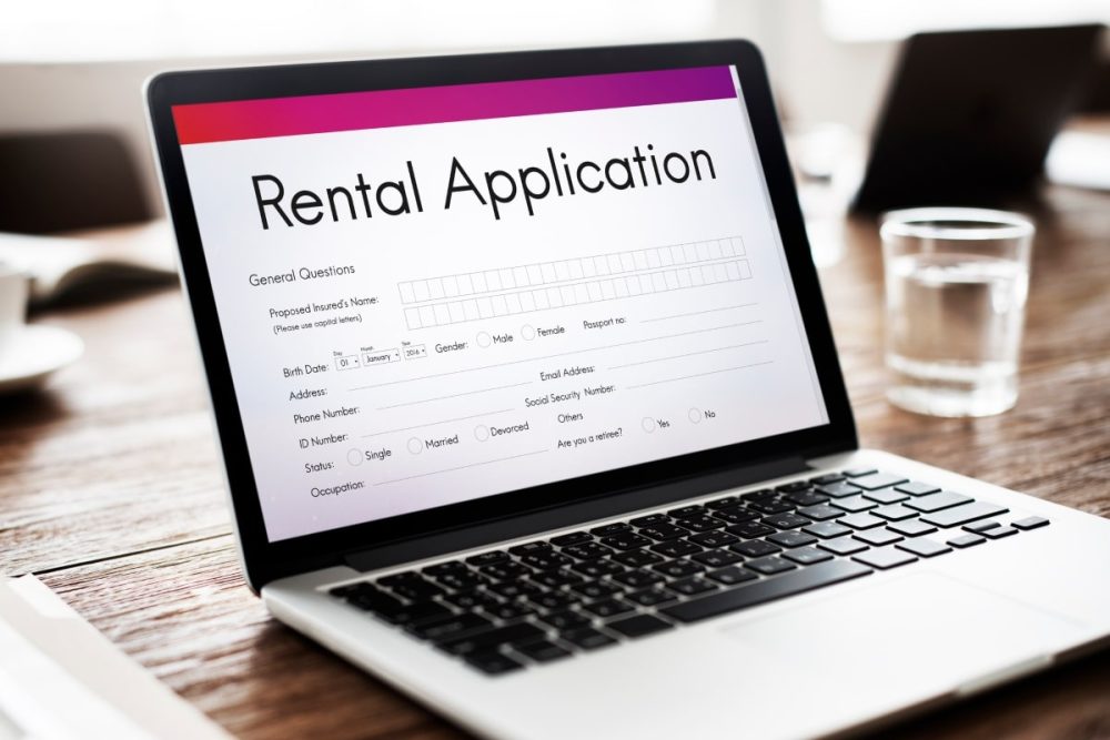 A laptop screen displaying an online rental application form, underscoring the importance of attention to detail, a key aspect in evaluating what makes a good tenant.