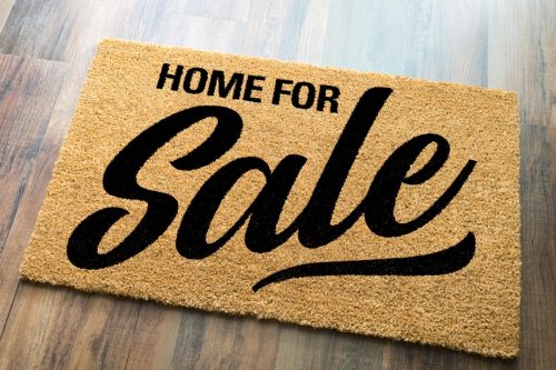 A 'Home for Sale' welcome mat serves as a reminder for sellers to ask real estate agents questions about their experience and track record.