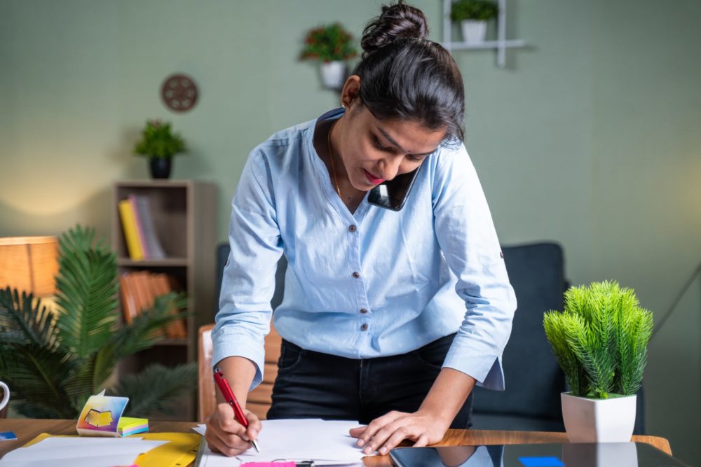 Person self managing their rental property and going through documents.