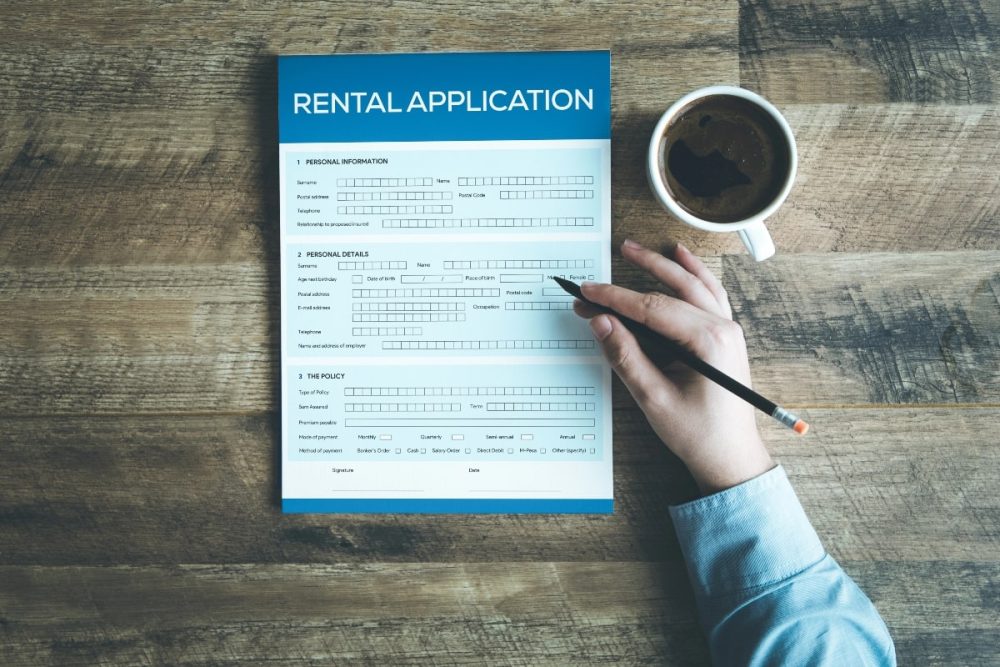 Rental application on desk, with a coffee cup.