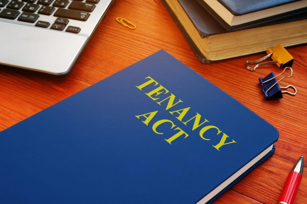 Tenancy Act book on a desk with stationery, highlighting legal guidelines for landlords and tenants in Western Australia.